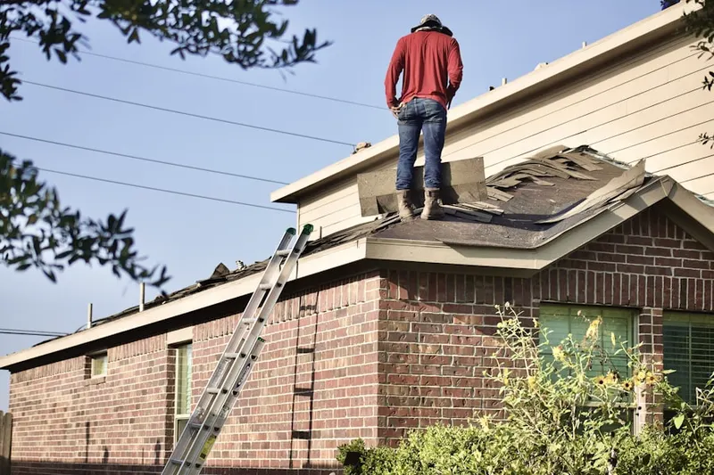 Professional roofer working on a residential roof in Robin Acres